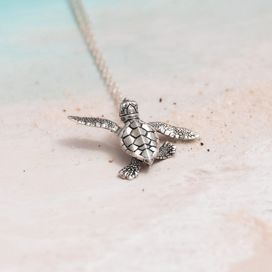 Collar Tortuga Bebé sobre arena